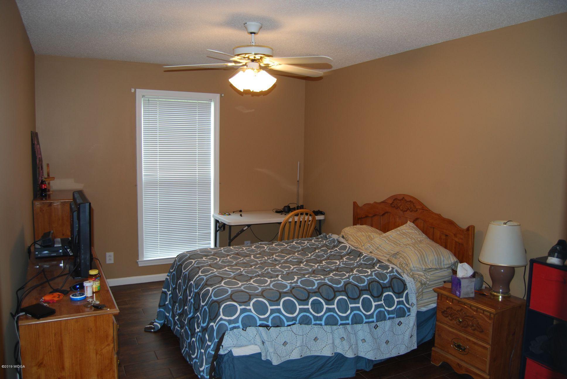 113 Marcar Road Macon, GA 31216 - Photo 14 of 31 a bedroom with a bed and a chandelier