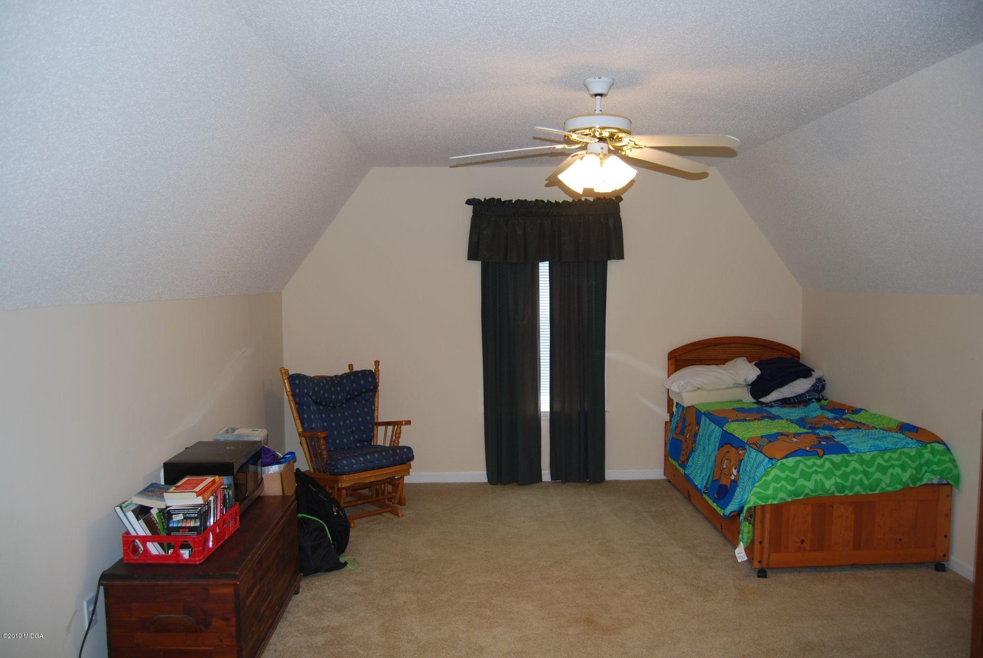 113 Marcar Road Macon, GA 31216 - Photo 17 of 31 a bedroom with bed and a chandelier