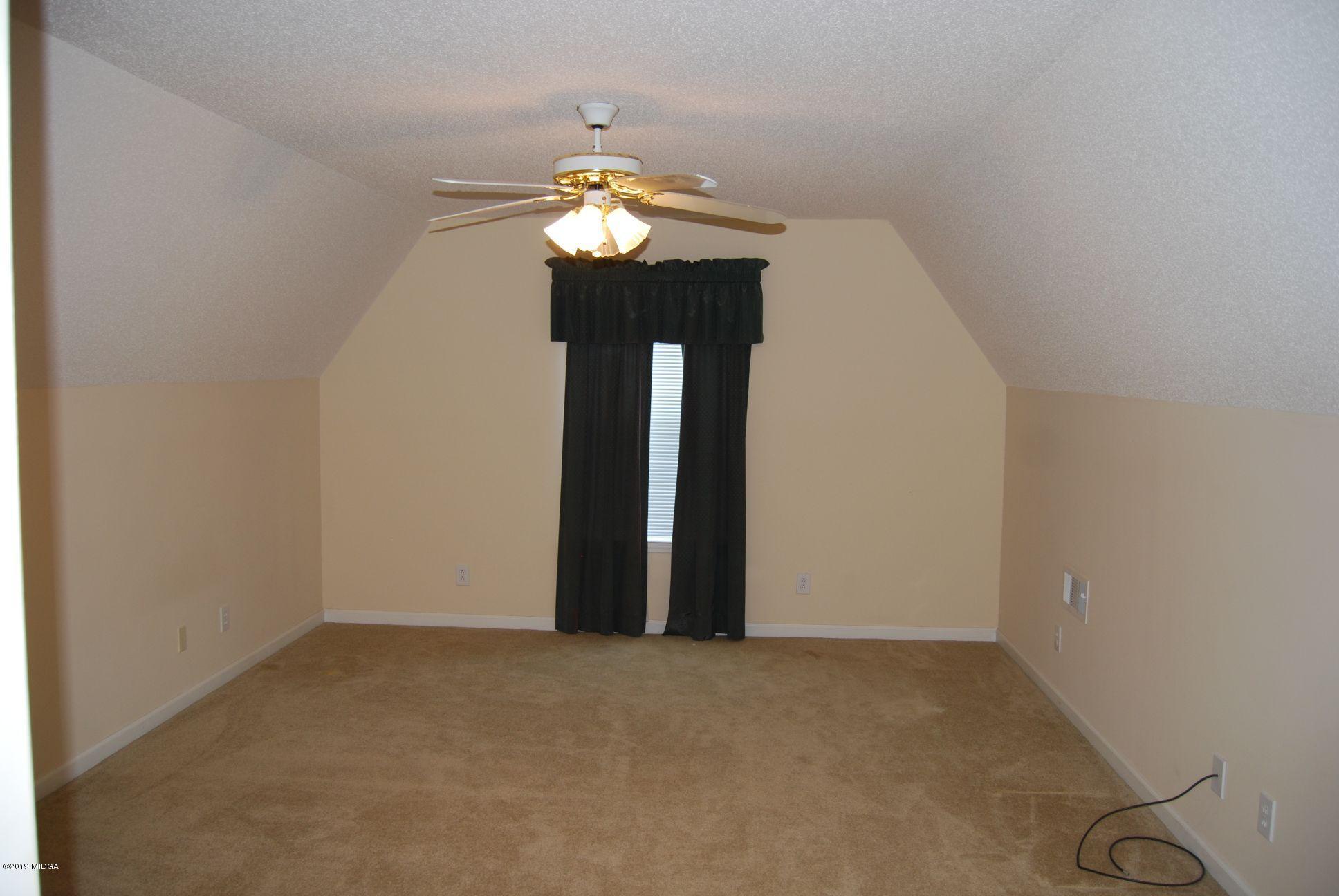 113 Marcar Road Macon, GA 31216 - Photo 19 of 31 a view of an empty room with a chandelier fan
