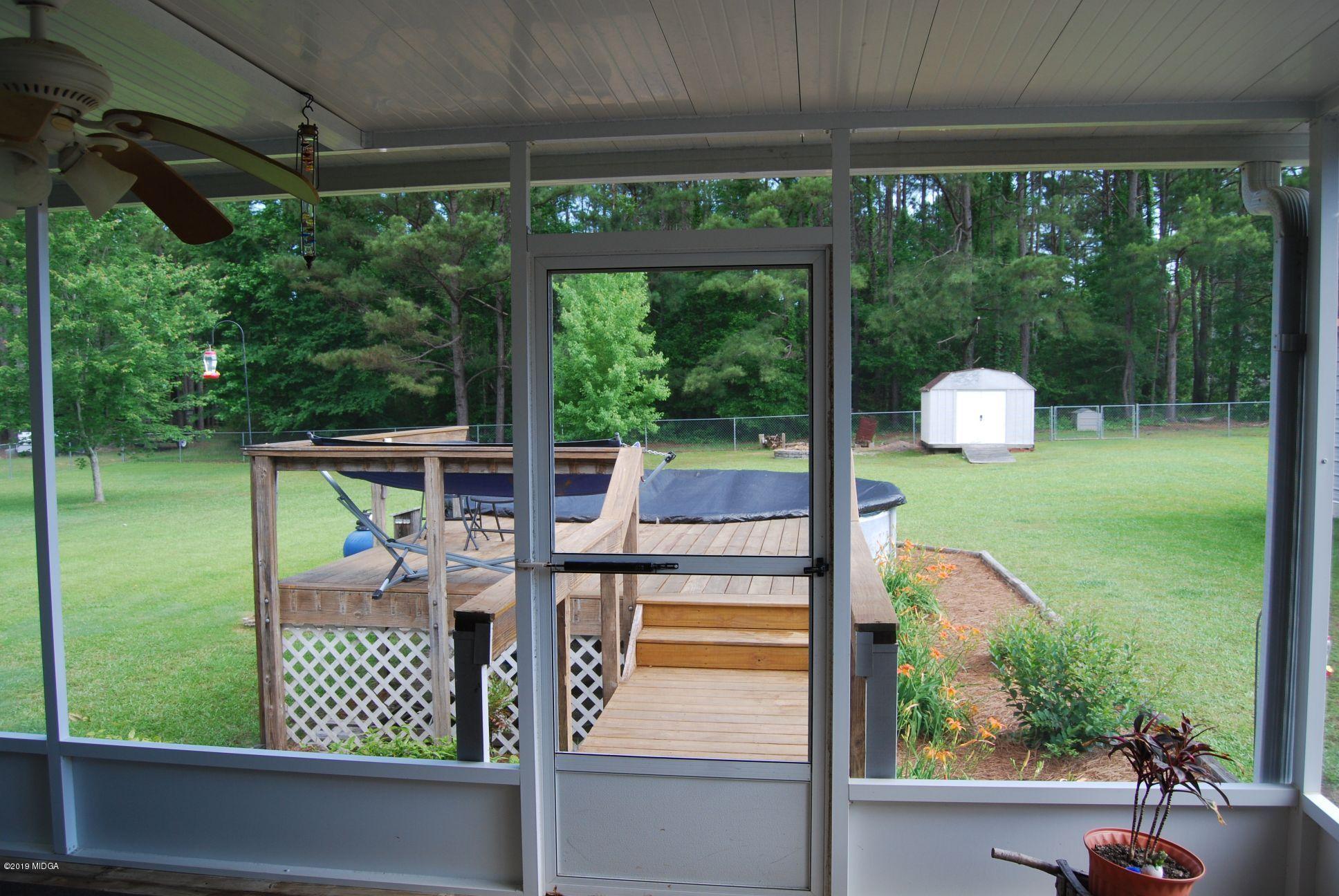 113 Marcar Road Macon, GA 31216 - Photo 20 of 31 a view of a chairs and table in patio with a yard