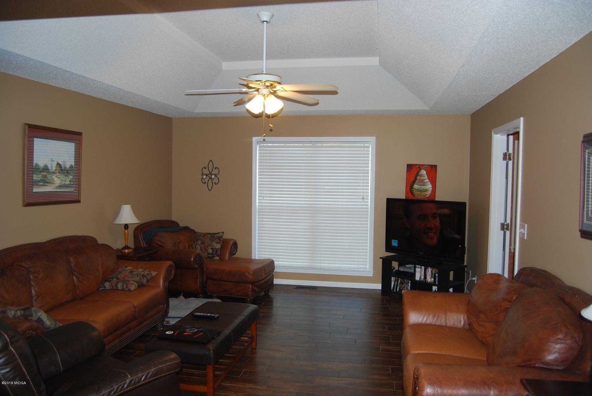 113 Marcar Road Macon, GA 31216 - Photo 3 of 31 a living room with furniture and a flat screen tv with wooden floor