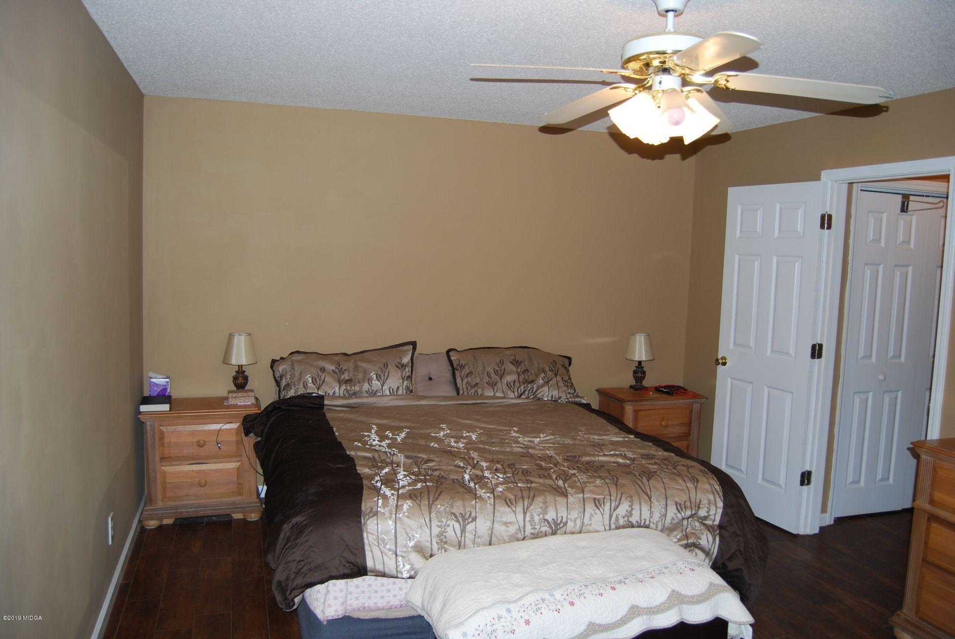 113 Marcar Road Macon, GA 31216 - Photo 8 of 31 a bedroom with a bed and a chandelier