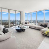 a living room with furniture and large windows