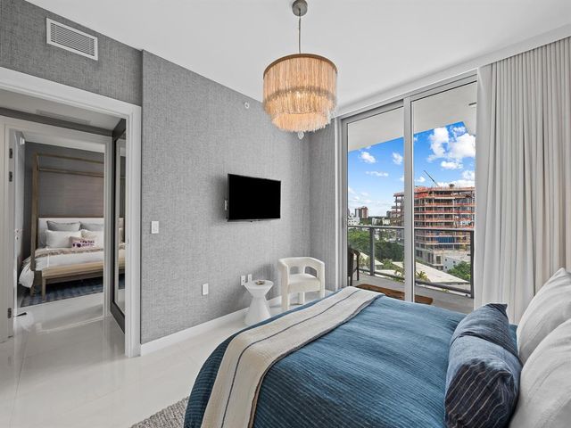 a bedroom with a bed and a chandelier