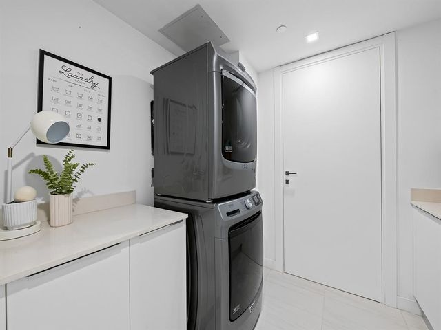 a view of kitchen with refrigerator and white wall