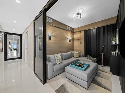 a living room with furniture and a lamp