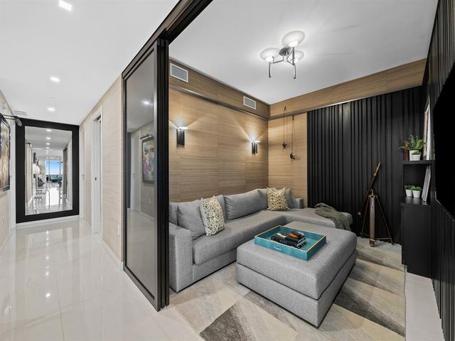 a living room with furniture and a lamp