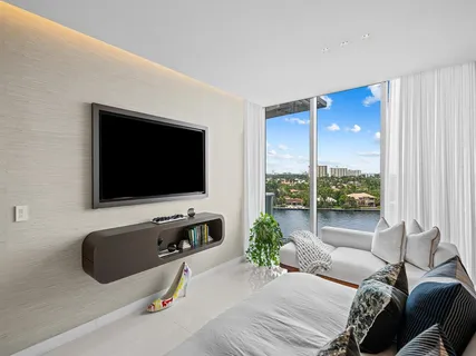 a living room with furniture and a floor to ceiling window
