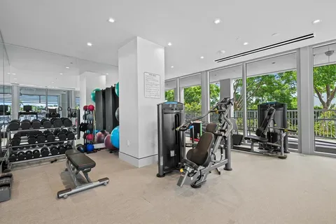 a living room with furniture a rug and kitchen view