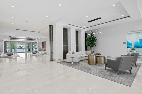 a living room with furniture a flat screen tv and a large window