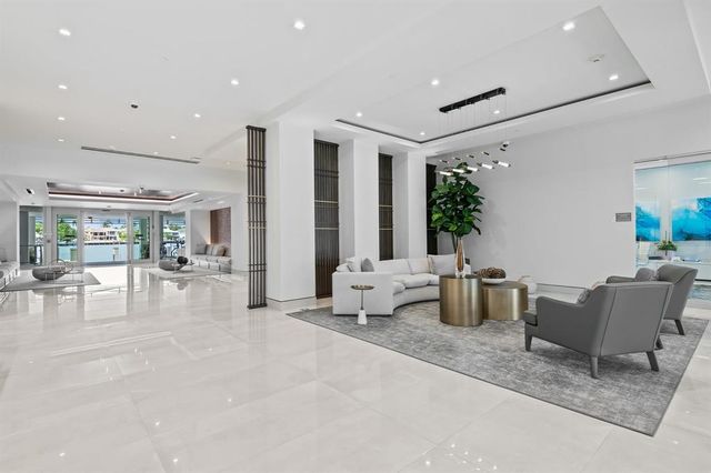 a living room with furniture a flat screen tv and a large window