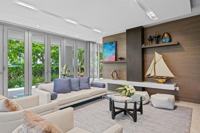 a kitchen with a sink stainless steel appliances and furniture