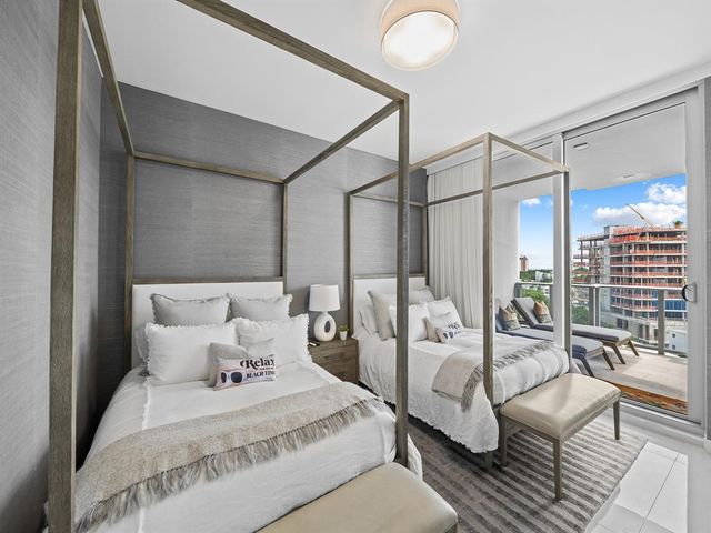 a large bedroom with a bed couch and a large window