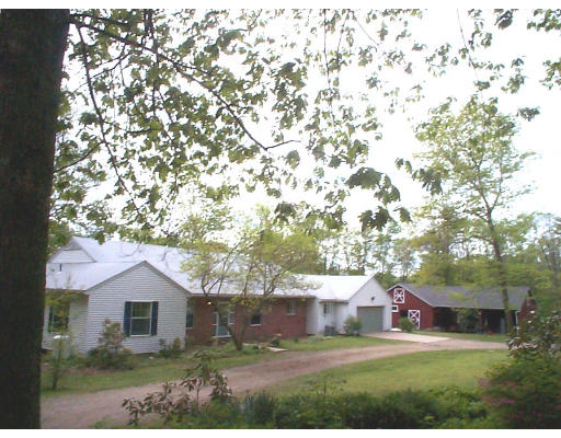 237 North Valley Road Pelham, MA 01002 - Photo 1 of 5 front view of house with a yard
