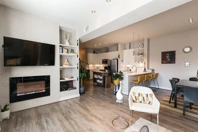 a living room with furniture a dining table and wooden floor
