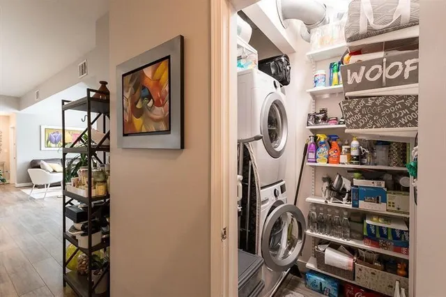 a living room with stainless steel appliances wooden floor and a fireplace