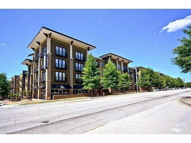 a kitchen with granite countertop a refrigerator stove and microwave