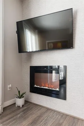 a bedroom with a bed and a television