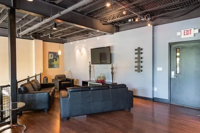 a view of a patio with a table and chairs and potted plants