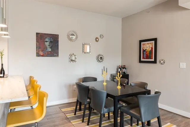 a living room with furniture a dining table and kitchen view