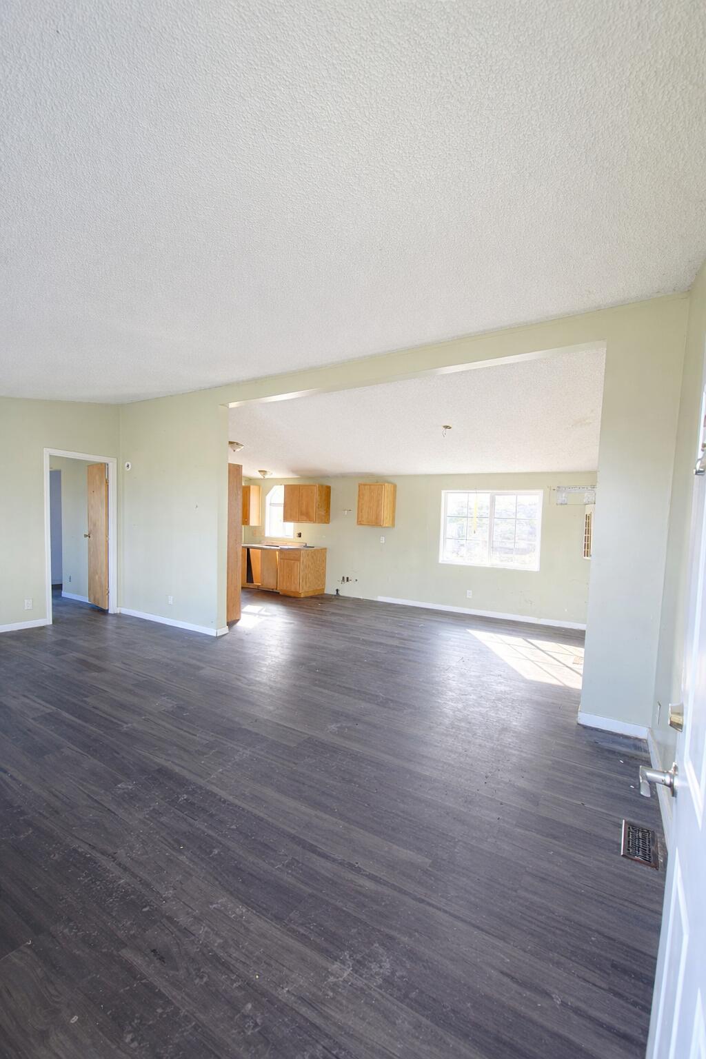 126 Butte Falls Highway Eagle Point, OR 97524 - Photo 2 of 10 a view of empty room with wooden floor