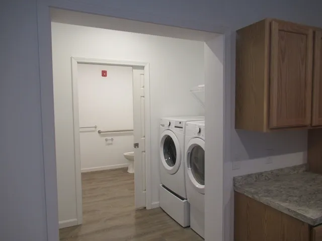a view of a refrigerator in kitchen and wooden floor