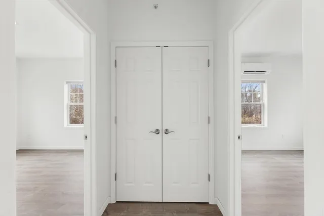 an empty room with windows and closet