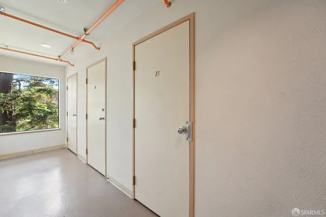 a view of a hallway with wooden shelves