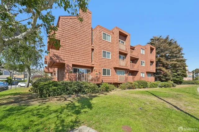 a front view of a building with garden