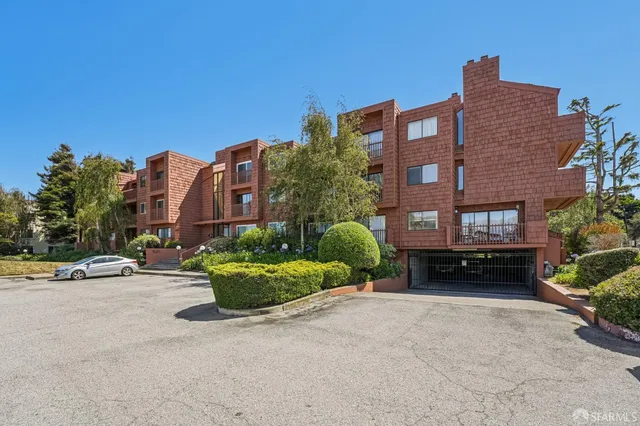 a car parked in front of a brick building