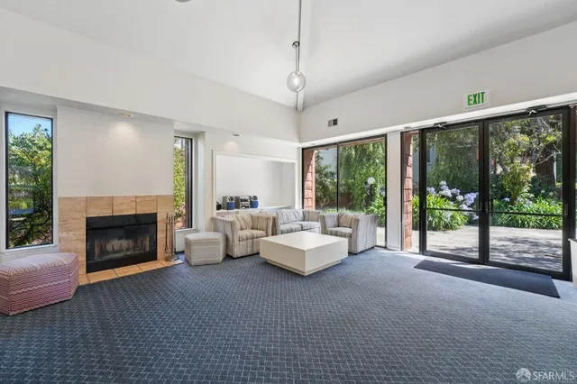 a living room with furniture large window and a fireplace