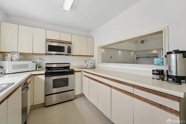 a kitchen with stainless steel appliances a sink cabinets and a counter top space