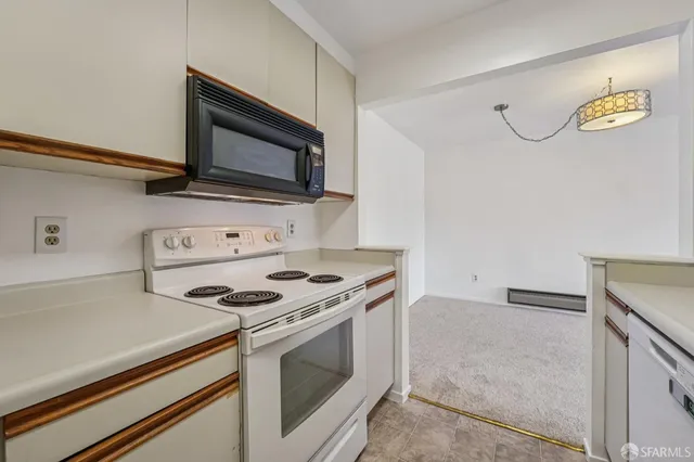 a kitchen with cabinets and a stove top oven