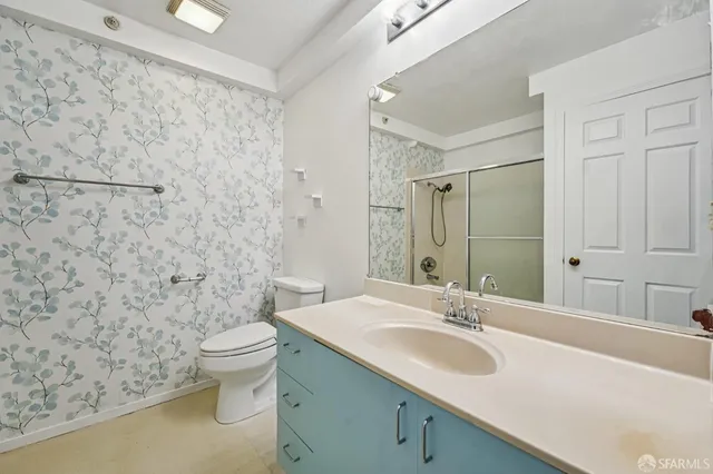 a bathroom with a sink toilet and shower