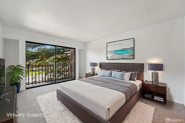 a bedroom with a large bed and a large window