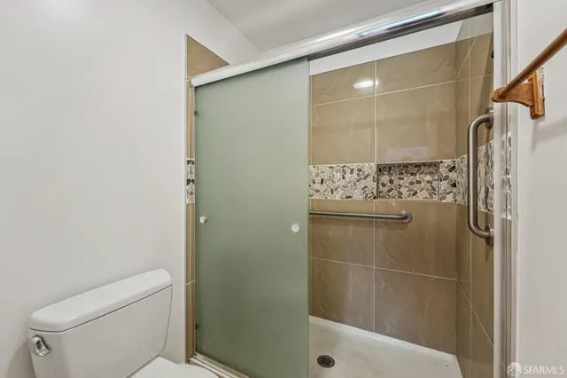 a bathroom with a shower and toilet