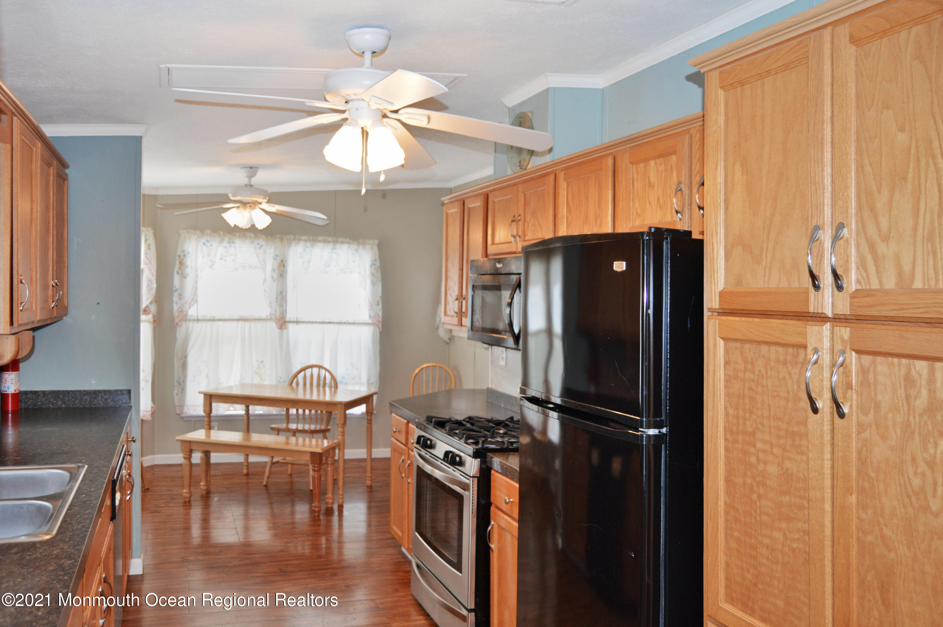 50 Roberts Road Toms River, NJ 08755 - Photo 6 of 23 a kitchen with stainless steel appliances granite countertop a refrigerator a stove and a sink with wooden floor