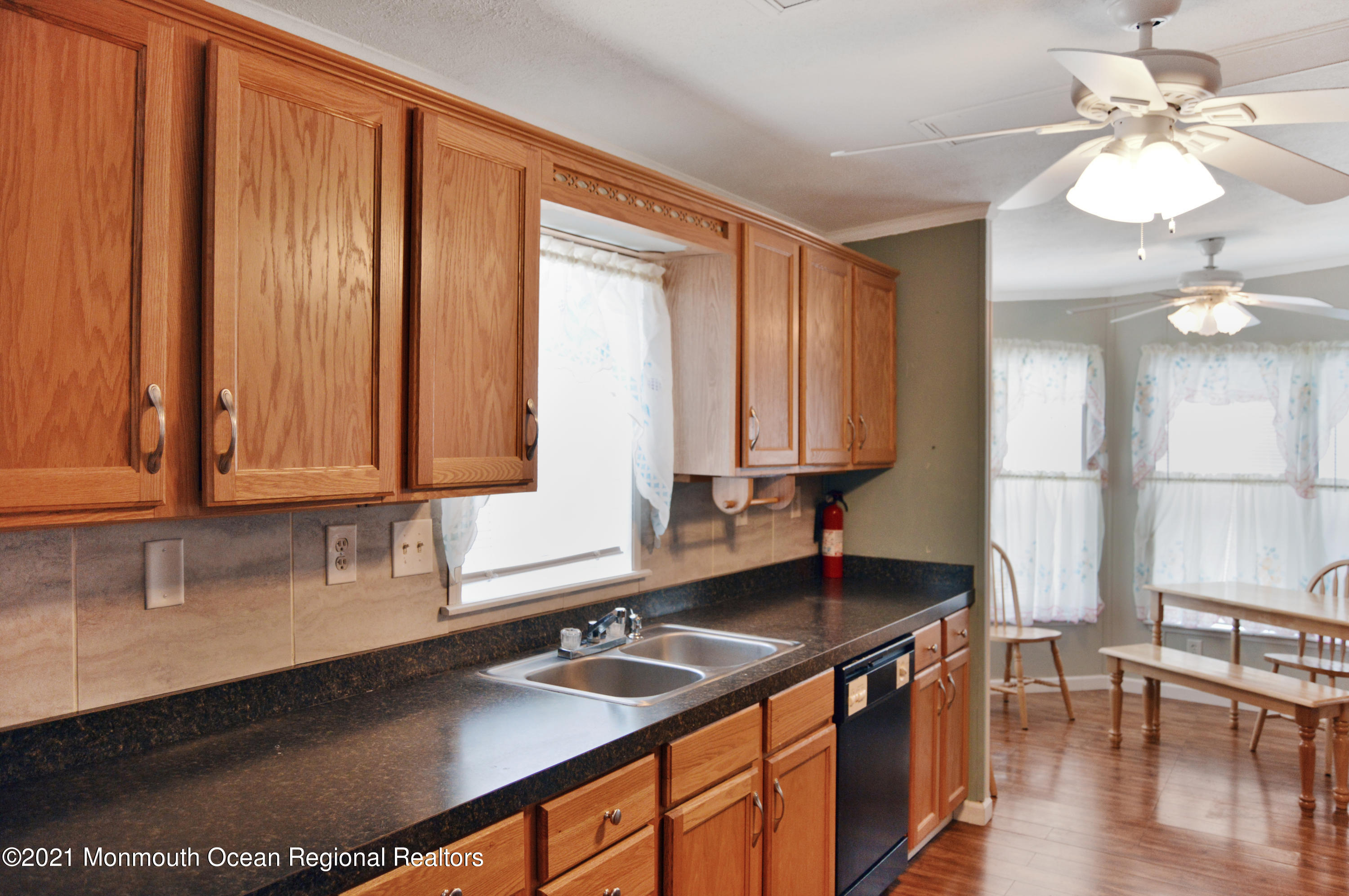 50 Roberts Road Toms River, NJ 08755 - Photo 9 of 23 a kitchen with stainless steel appliances granite countertop a sink a stove and a microwave