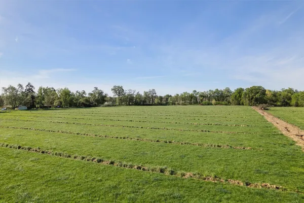 a view of a field with an outdoor space