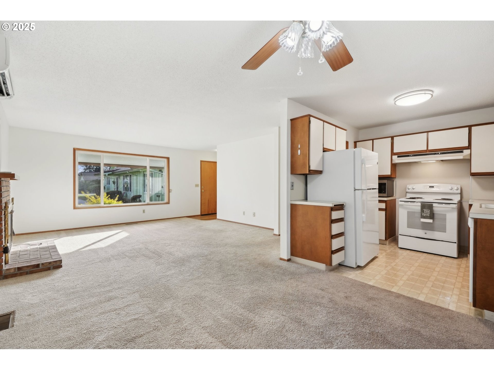 12325 Southeast Main Street Portland, OR 97233 - Photo 13 of 46 a kitchen with stainless steel appliances granite countertop a stove a sink and a refrigerator with wooden floor