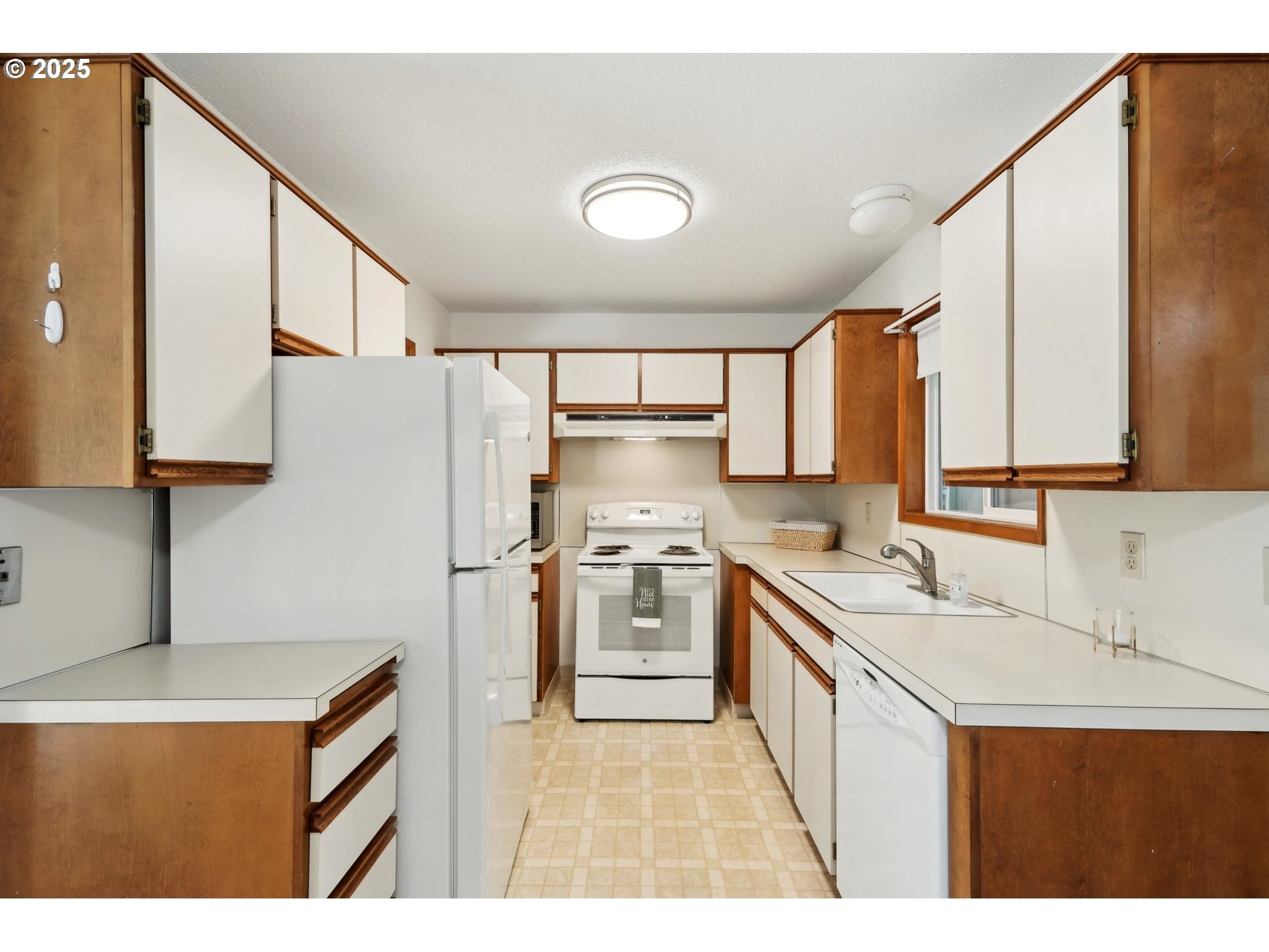 12325 Southeast Main Street Portland, OR 97233 - Photo 14 of 46 a kitchen with a sink a stove a refrigerator and cabinets
