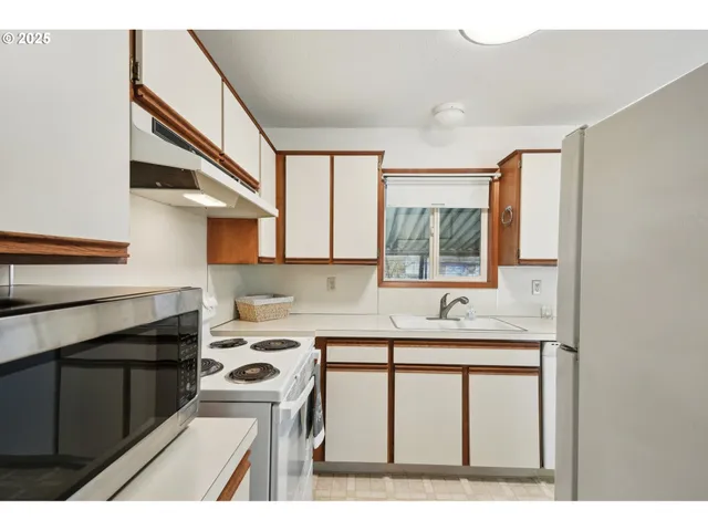a kitchen with a sink cabinets and appliances