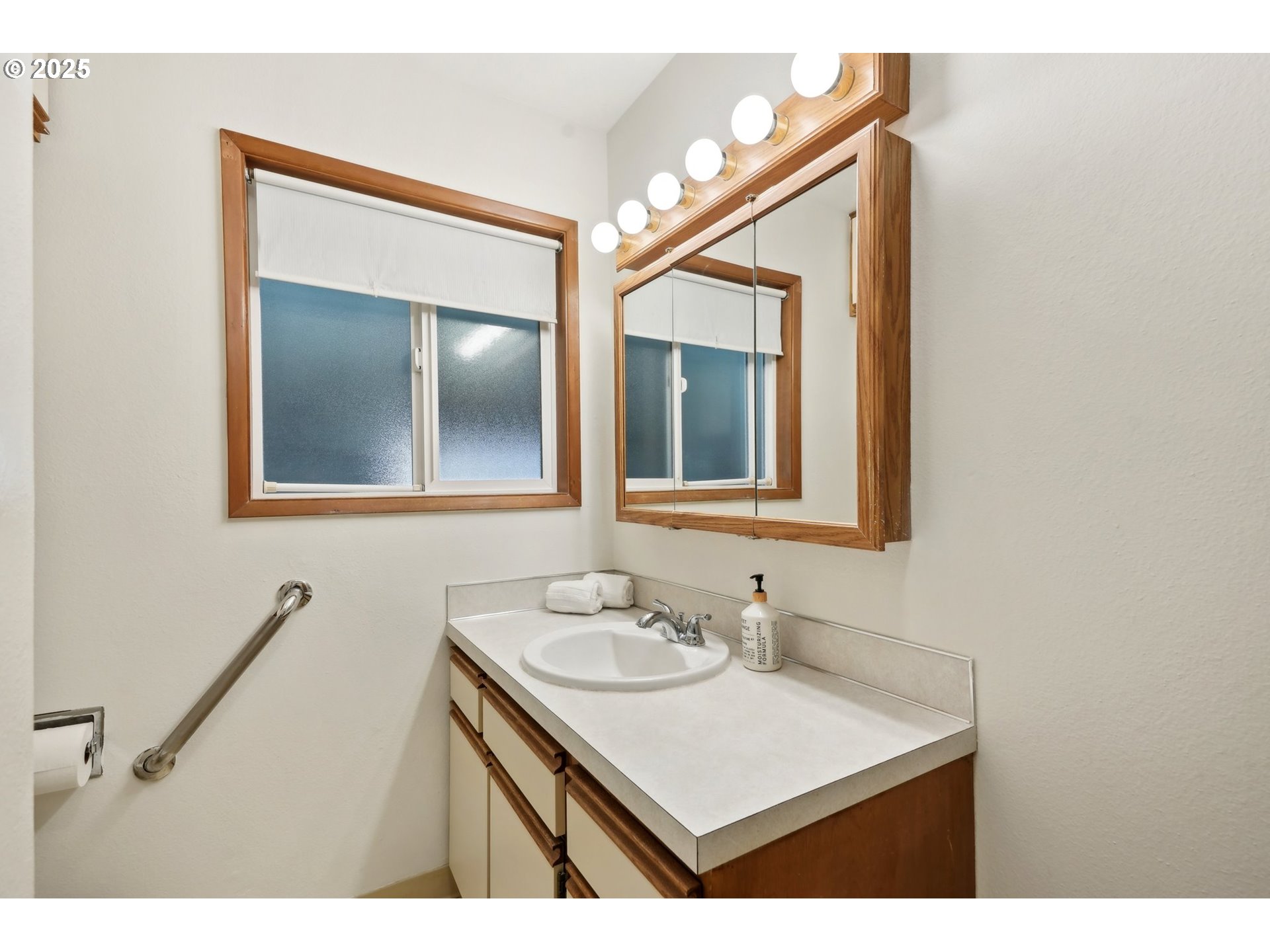 12325 Southeast Main Street Portland, OR 97233 - Photo 19 of 46 a bathroom with a sink vanity and a mirror