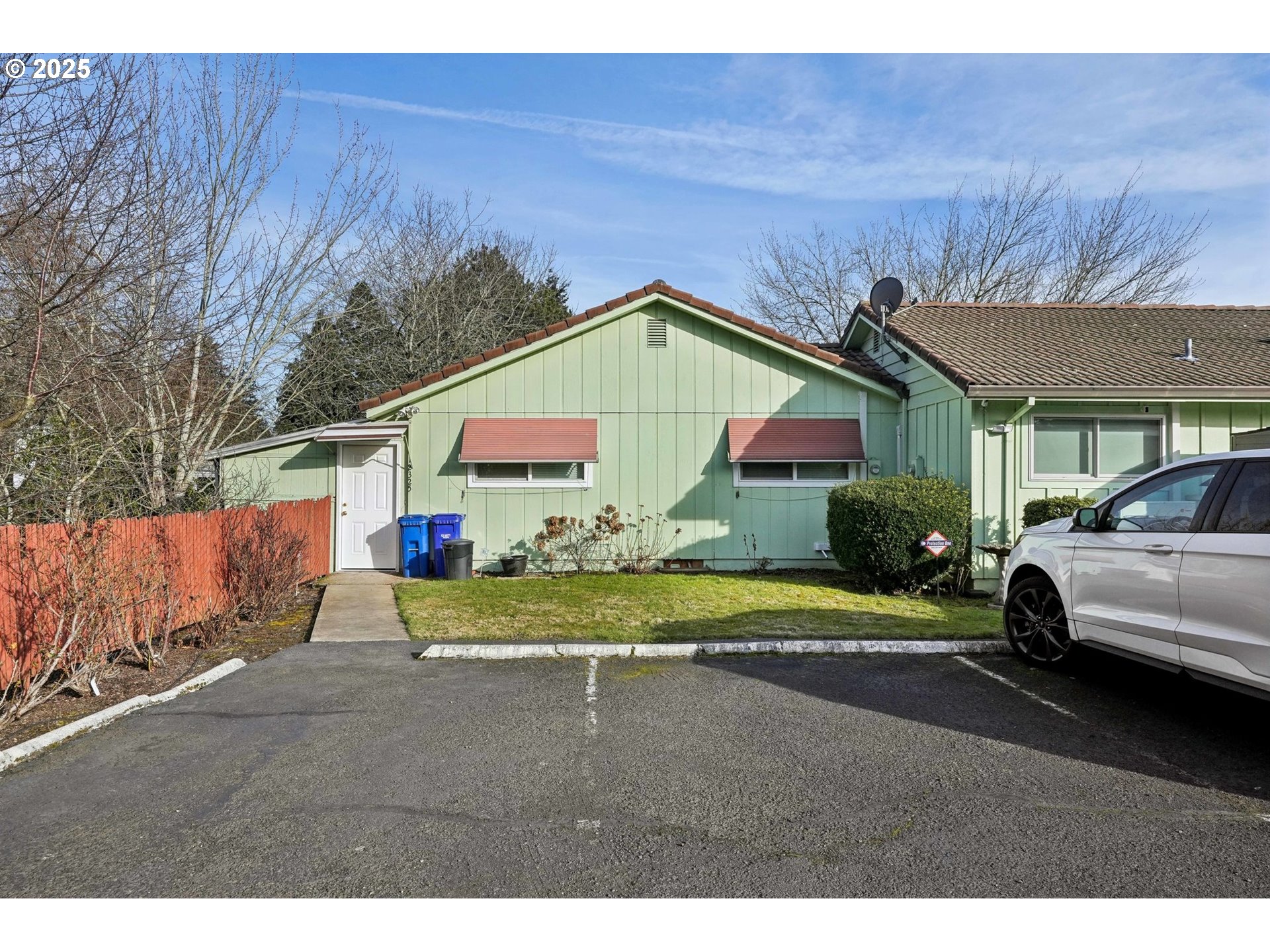 12325 Southeast Main Street Portland, OR 97233 - Photo 31 of 46 a front view of a house with a yard and garage