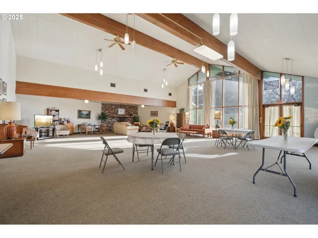 a living room with lots of furniture and a large window