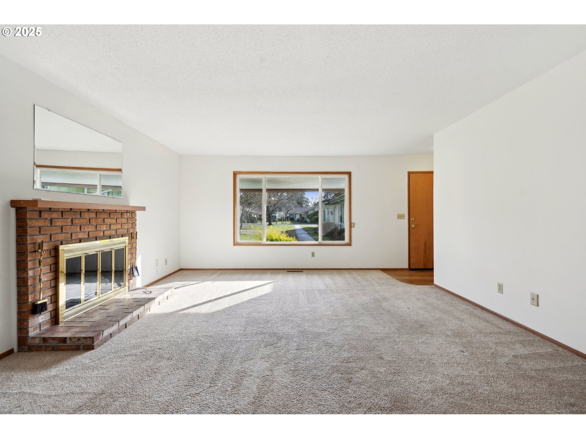 12325 Southeast Main Street Portland, OR 97233 - Photo 6 of 46 a view of an empty room with a fireplace
