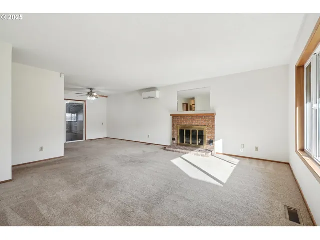 a view of an empty room with a fireplace