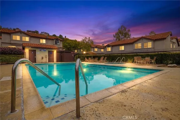 a view of a swimming pool with a lounge chairs