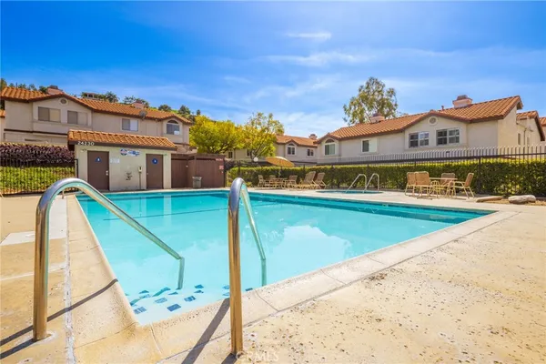 a view of a swimming pool with an outdoor seating
