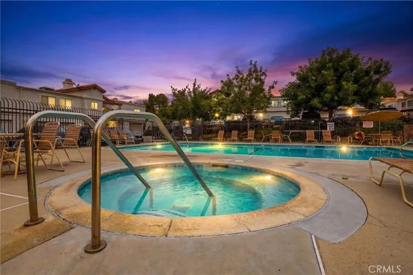a swimming pool with outdoor seating and yard